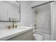 Bathroom featuring a vanity and shower-tub combination with a white tile surround at 5341 E Sheena Dr, Scottsdale, AZ 85254