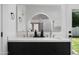 Modern bathroom with double sinks, white countertops, and a view of an exterior yard space at 5341 E Sheena Dr, Scottsdale, AZ 85254