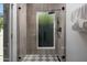 Modern shower featuring floor-to-ceiling tile and sleek black fixtures at 5341 E Sheena Dr, Scottsdale, AZ 85254