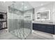 Modern bathroom featuring a glass-enclosed shower, dual vanities, and a spacious walk-in closet for convenience at 5401 N 25Th St, Phoenix, AZ 85016