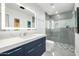 Bright bathroom showcases gray tiling, sleek fixtures, glass shower, and modern vanity at 5401 N 25Th St, Phoenix, AZ 85016