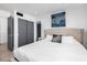 Bright bedroom features white bedding, a closet with sliding doors, and modern decor at 5401 N 25Th St, Phoenix, AZ 85016
