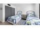 Spacious bedroom featuring twin beds, wood floors, and modern decor at 5401 N 25Th St, Phoenix, AZ 85016