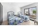 Spacious bedroom featuring twin beds, wood floors, and a sliding door to patio at 5401 N 25Th St, Phoenix, AZ 85016