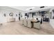 Open-concept dining area featuring modern chandelier, seating for six and an adjacent kitchen at 5401 N 25Th St, Phoenix, AZ 85016