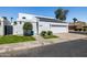 Well-maintained home with modern lighting, a two-car garage, and vibrant landscaping creating an inviting curb appeal at 5401 N 25Th St, Phoenix, AZ 85016