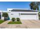 Contemporary home featuring clean lines, a well-manicured yard, and an attached two-car garage, displaying modern curb appeal at 5401 N 25Th St, Phoenix, AZ 85016