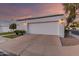 Modern home featuring a bright white exterior, a two-car garage, and professionally landscaped front yard at 5401 N 25Th St, Phoenix, AZ 85016