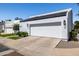 Charming single-story house with a white facade, two-car garage, and professionally landscaped front yard at 5401 N 25Th St, Phoenix, AZ 85016