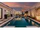 Gorgeous pool with lounge chairs, a fire pit, and modern landscaping for a resort-style backyard retreat at 5401 N 25Th St, Phoenix, AZ 85016