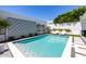Outdoor pool area with blue tiling, sun loungers, and lush greenery at 5401 N 25Th St, Phoenix, AZ 85016