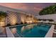 Sparkling pool with elegant tile work, lush landscaping, and inviting lounge chairs, perfect for relaxation and recreation at 5401 N 25Th St, Phoenix, AZ 85016