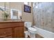 Well-lit bathroom with a vanity, toilet, and shower-tub combo at 6133 W Fetlock Ter, Phoenix, AZ 85083
