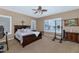 Bright bedroom with ceiling fan, shuttered windows, and comfortable king bed at 6133 W Fetlock Ter, Phoenix, AZ 85083