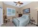 Calm bedroom featuring a metal frame bed and window with plantation shutters at 6133 W Fetlock Ter, Phoenix, AZ 85083