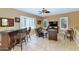 Open concept living room with bar area, tile flooring, and neutral decor at 6133 W Fetlock Ter, Phoenix, AZ 85083