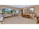 Well-lit living room and dining area with views of the private backyard at 6133 W Fetlock Ter, Phoenix, AZ 85083