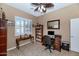 Office space featuring tile floors, plantation shutters, and modern desk at 6133 W Fetlock Ter, Phoenix, AZ 85083