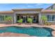 Backyard featuring a sparkling pool, a covered patio, mature palm trees, and desert landscaping, ideal for outdoor enjoyment at 6133 W Fetlock Ter, Phoenix, AZ 85083
