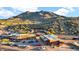 An aerial view of a desert mountain community and parking lot with multiple businesses at 6525 E Cave Creek Rd # 40, Cave Creek, AZ 85331