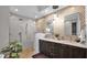 Sleek bathroom featuring a glass-enclosed shower, double vanity, and patterned accent wall at 6525 E Cave Creek Rd # 40, Cave Creek, AZ 85331