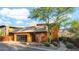 Contemporary home showcasing a modern garage door, unique copper accents, and lush desert landscaping with mountain views at 6525 E Cave Creek Rd # 40, Cave Creek, AZ 85331