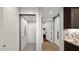 Hallway featuring a residential elevator, sliding barn door, and access to the kitchen area at 6525 E Cave Creek Rd # 40, Cave Creek, AZ 85331