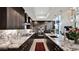Modern kitchen featuring dark cabinetry, granite countertops, stainless steel appliances, and stylish pendant lighting at 6525 E Cave Creek Rd # 40, Cave Creek, AZ 85331