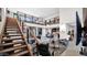 Expansive living room featuring contemporary furniture, a staircase leading to a second-floor balcony, and modern decor at 6525 E Cave Creek Rd # 40, Cave Creek, AZ 85331