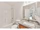 Bathroom with tub and shower, granite vanity, and a framed mirror at 664 E Windsor Dr, Gilbert, AZ 85296