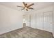 Neutral bedroom with a ceiling fan, carpeted floor, closet, and doorway at 664 E Windsor Dr, Gilbert, AZ 85296