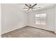 Bright carpeted bedroom featuring a ceiling fan and window with coverings at 664 E Windsor Dr, Gilbert, AZ 85296