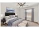 Serene bedroom with a padded headboard, ceiling fan, and soft natural light from the window at 664 E Windsor Dr, Gilbert, AZ 85296