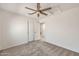 Bedroom with ceiling fan, carpeted floor and closet with bi-fold doors at 664 E Windsor Dr, Gilbert, AZ 85296