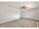 Bedroom featuring neutral carpet, a ceiling fan, and a closet with mirrored doors at 664 E Windsor Dr, Gilbert, AZ 85296