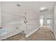 Upstairs hallway featuring neutral carpet and a modern chandelier at 664 E Windsor Dr, Gilbert, AZ 85296