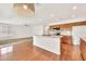 An open concept kitchen featuring hardwood floors, a center island, and stainless steel appliances at 664 E Windsor Dr, Gilbert, AZ 85296