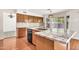 Kitchen area with stainless steel appliances, granite countertops, wood cabinetry, and hardwood flooring at 664 E Windsor Dr, Gilbert, AZ 85296