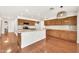 A spacious kitchen with hardwood floors, a center island, and shaker cabinets providing ample storage at 664 E Windsor Dr, Gilbert, AZ 85296