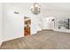 Bright living room with a vaulted ceiling, chandelier, and views of the kitchen and front entrance at 664 E Windsor Dr, Gilbert, AZ 85296