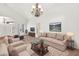 Inviting living room featuring a chandelier, plush seating, and tasteful decor accents at 664 E Windsor Dr, Gilbert, AZ 85296