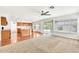 Bright living space with hardwood floors, fan, and sliding glass doors leading to the backyard at 664 E Windsor Dr, Gilbert, AZ 85296