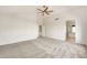 Spacious main bedroom featuring neutral carpet, a ceiling fan, and ensuite bathroom at 664 E Windsor Dr, Gilbert, AZ 85296