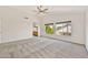 Bright main bedroom with neutral carpet, ceiling fan, large windows, and ensuite bathroom at 664 E Windsor Dr, Gilbert, AZ 85296