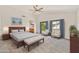 Spacious primary bedroom with large windows, an ensuite bathroom, and comfortable sitting area at 664 E Windsor Dr, Gilbert, AZ 85296
