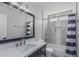 Stylish bathroom with modern fixtures, vanity, and shower-tub combination with shower curtain at 676 W Shawnee Dr, Chandler, AZ 85225