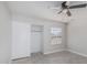 Bright bedroom featuring modern ceiling fan, window, and closet with sliding doors at 676 W Shawnee Dr, Chandler, AZ 85225