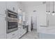 Gourmet kitchen with stainless appliances, marble countertops, and modern fixtures at 676 W Shawnee Dr, Chandler, AZ 85225
