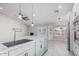 Gourmet kitchen featuring modern appliances, a large island, and access to the backyard pool at 676 W Shawnee Dr, Chandler, AZ 85225