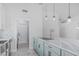 Modern kitchen with light blue cabinetry, marble countertops, and stainless steel appliances at 676 W Shawnee Dr, Chandler, AZ 85225